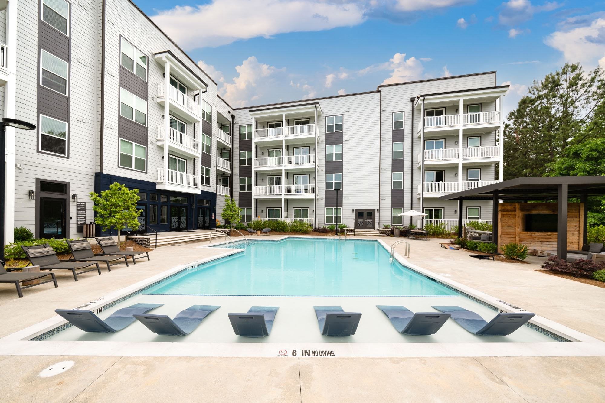 a swimming pool in front of an apartment building